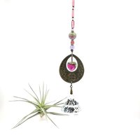 With a nod to bright tones and textures, this one of a kind large crystal sun catcher hanging, holds a gorgeous shape and design featuring a 60mm faceted crystal prism (epic rainbow maker) with unique gemstones. An exceptional piece and quite lovely when hung.  Finished with a sturdy chain and solid  hook for easy hanging.