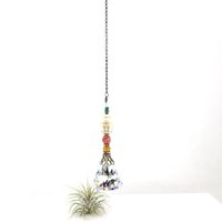 This charming handmade crystal hanging will adorn any room with rainbows and lively reflections, making it a delightful addition for yourself or a thoughtful gift that will be treasured.Featuring a high-quality, medium (40mm) faceted crystal prism, meticulously hand-strung with Howlite gemstone Buddha Focal, Cherry Quartz and distinctive Czech glass beads. It is completed with chain and hook, ensuring effortless hanging and allowing gentle movement that makes the rainbows dance.