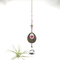 With a nod to bright tones and textures, this one of a kind large crystal sun catcher hanging, holds a gorgeous shape and design featuring a 60mm faceted crystal prism (epic rainbow maker) with unique gemstones. An exceptional piece and quite lovely when hung.  Finished with a sturdy chain and solid  hook for easy hanging.