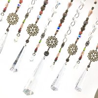 Adorn your personal space with our unique, exceptional chandelier beaded curtain or what we lovingly refer to as a "Window Necklace". The fluid nature (similar to a necklace) of this eleven strand hanging, allows for gentle movement after being hung which creates wonderful and beautiful reflections with just about any light and atmosphere.New Asfour chandelier crystal prisms (Epic Rainbows!). Beads and gemstones include: Aventurine, Green Quartz, Green Kyanite. Vintage and new Czech glass.