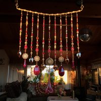 Adorn your personal space with our unique, exceptional chandelier beaded curtain or what we lovingly refer to as a "Window Necklace".  The fluid nature (similar to a necklace) of this eleven strand hanging, allows for gentle movement after being hung which creates wonderful and beautiful reflections with just about any light and atmosphere.

Vintage Murano chandelier focal, new and vintage chandelier prism, and stamped Strass Swarovski crystal. Beads: Ruby, Swarovski, and Czech glass beads.