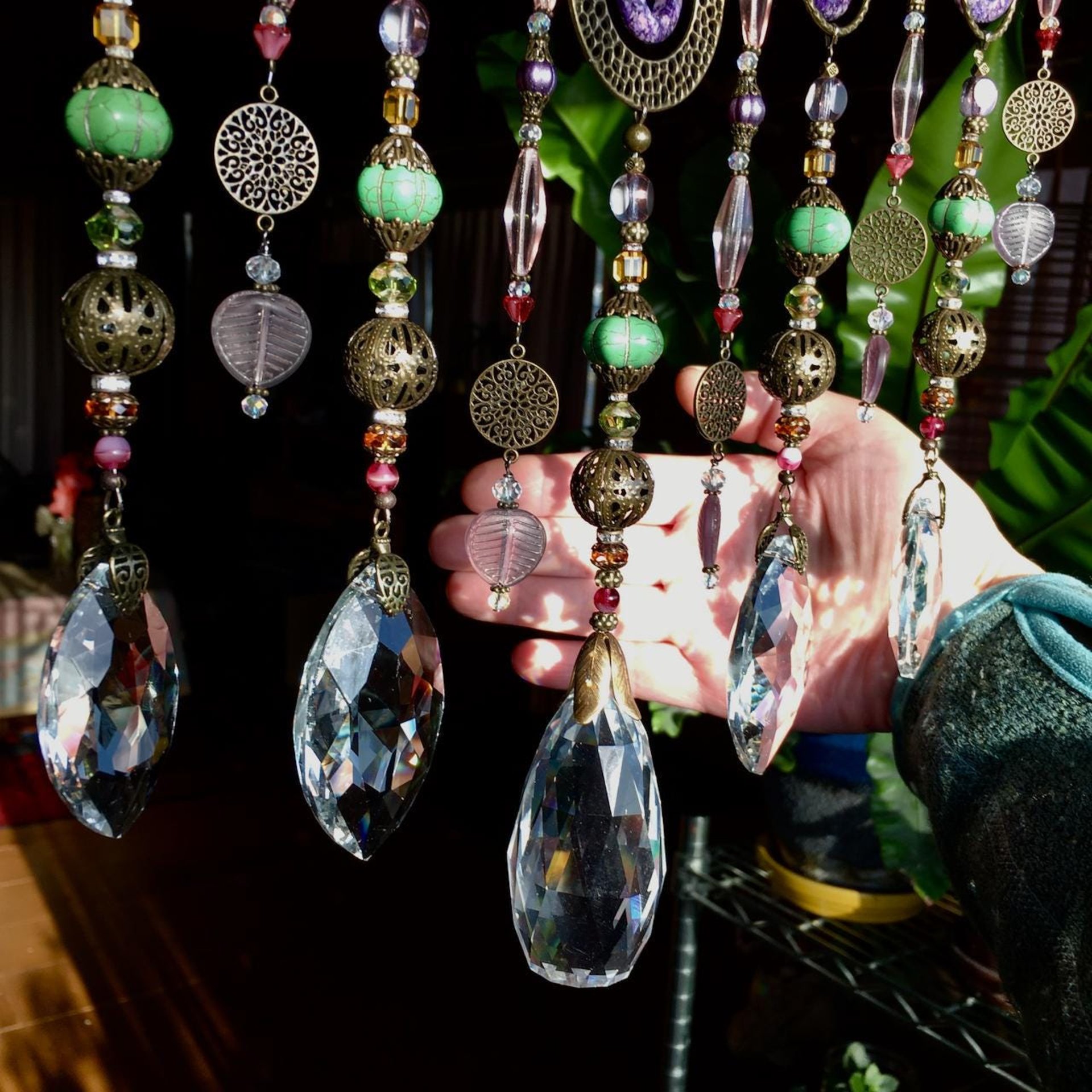 Adorn your personal space with our unique, exceptional chandelier beaded curtain or what we lovingly refer to as a "Window Necklace".  The fluid nature (similar to a necklace) of this eleven strand hanging, allows for gentle movement after being hung which creates wonderful and beautiful reflections with just about any light and atmosphere.Chandelier crystal prisms, creating epic rainbows! Gemstones and Crystal include: Malaysian Jade, Howlite, Purple Lace Agate, vintage and new Czech glass.