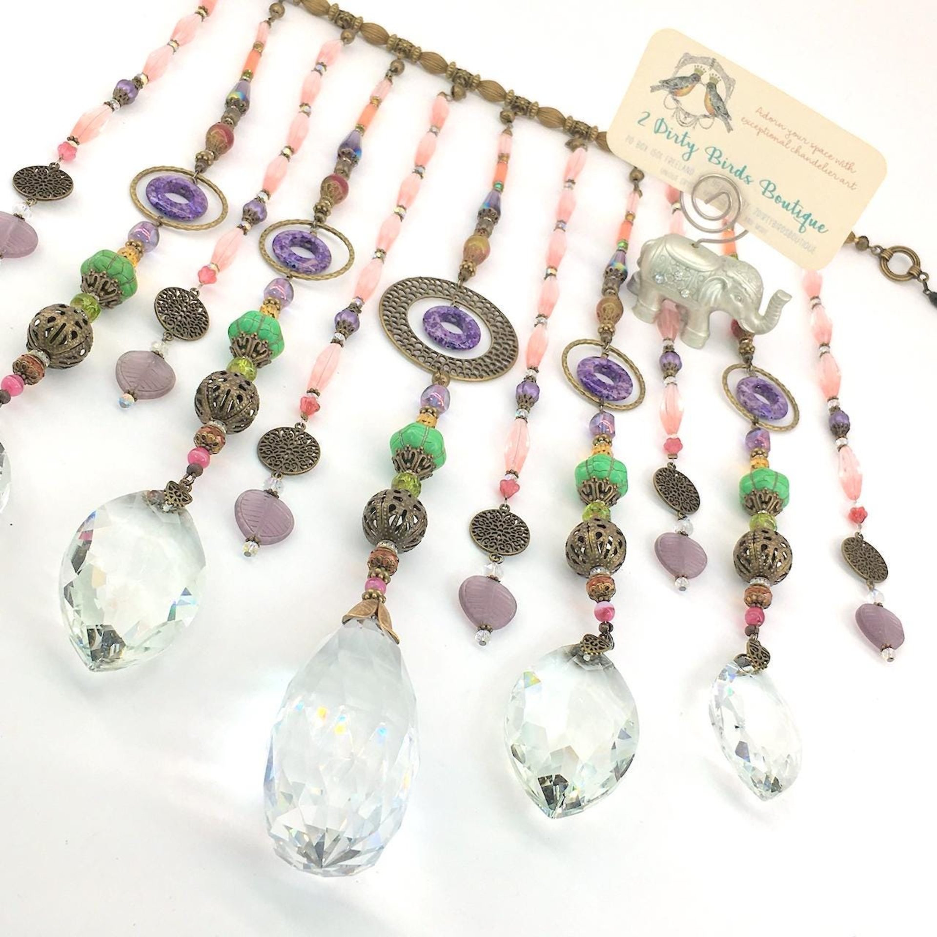 Adorn your personal space with our unique, exceptional chandelier beaded curtain or what we lovingly refer to as a "Window Necklace".  The fluid nature (similar to a necklace) of this eleven strand hanging, allows for gentle movement after being hung which creates wonderful and beautiful reflections with just about any light and atmosphere.Chandelier crystal prisms, creating epic rainbows! Gemstones and Crystal include: Malaysian Jade, Howlite, Purple Lace Agate, vintage and new Czech glass.