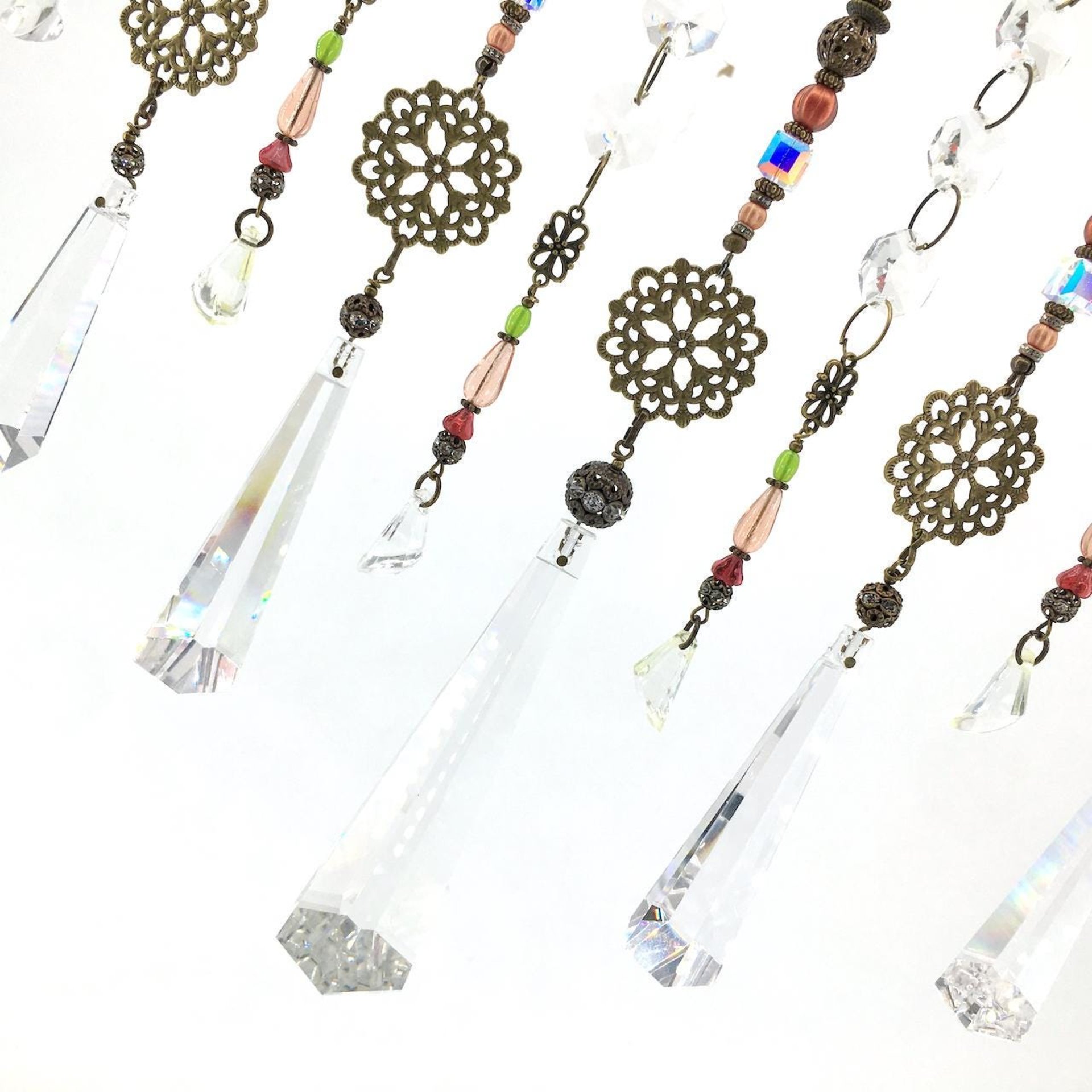 Adorn your personal space with our unique, exceptional chandelier beaded curtain or what we lovingly refer to as a "Window Necklace". The fluid nature (similar to a necklace) of this eleven strand hanging, allows for gentle movement after being hung which creates wonderful and beautiful reflections with just about any light and atmosphere.New Asfour chandelier crystal prisms (Epic Rainbows!). Beads and gemstones include: Aventurine, Green Quartz, Green Kyanite. Vintage and new Czech glass.