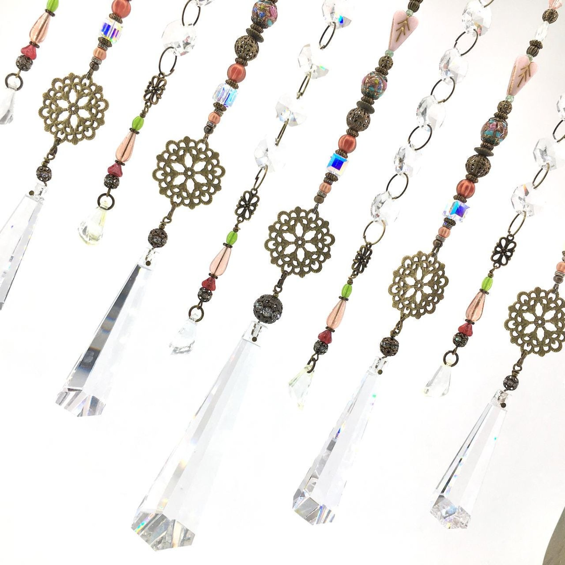 Adorn your personal space with our unique, exceptional chandelier beaded curtain or what we lovingly refer to as a "Window Necklace". The fluid nature (similar to a necklace) of this eleven strand hanging, allows for gentle movement after being hung which creates wonderful and beautiful reflections with just about any light and atmosphere.New Asfour chandelier crystal prisms (Epic Rainbows!). Beads and gemstones include: Aventurine, Green Quartz, Green Kyanite. Vintage and new Czech glass.